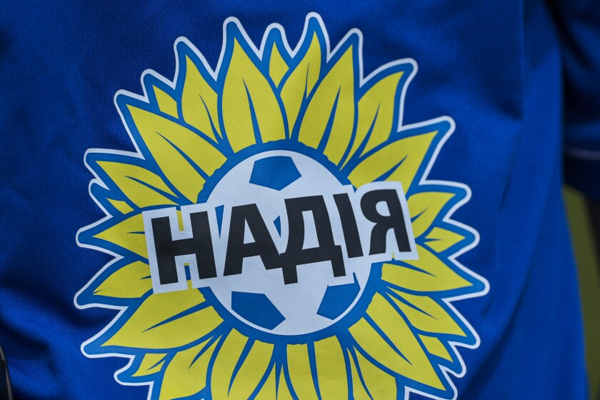 Soccer players in blue and yellow jerseys