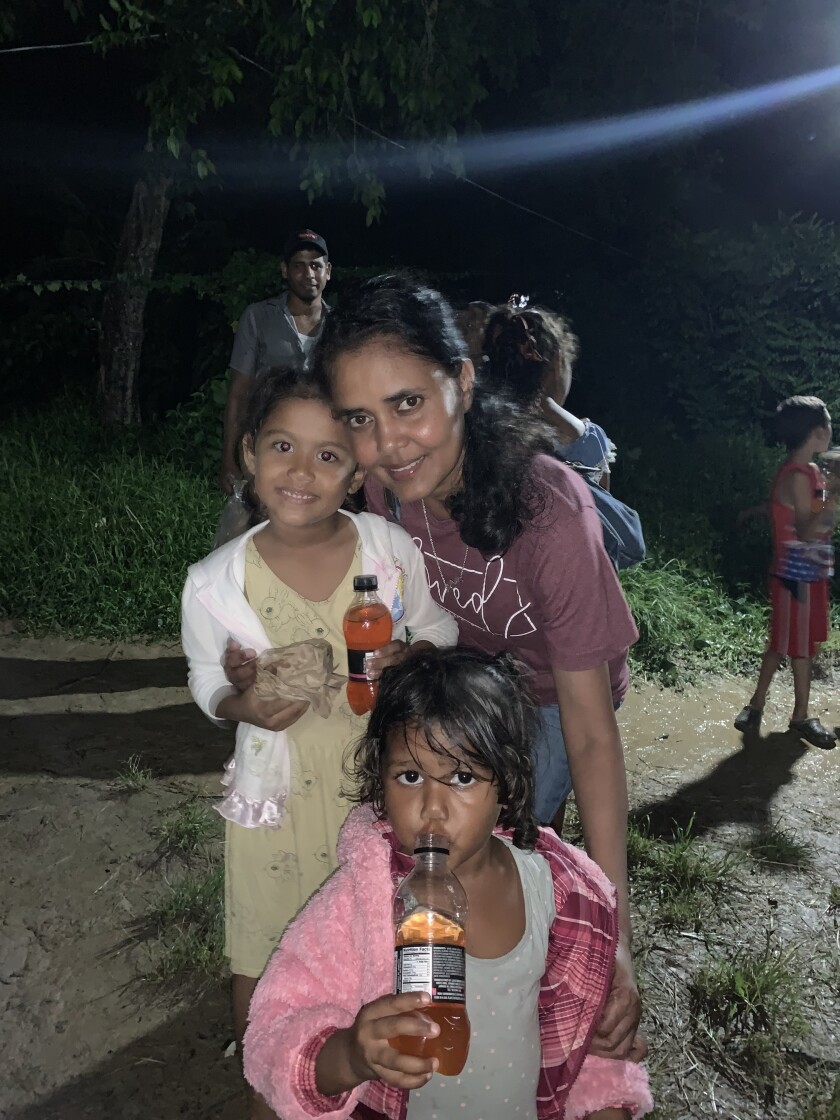 Guyana_Marcia with two small girls in the village of Tusion which borders the Atlantic Ocean_ it is in the floodplain so every new moon and full moon that area is under water.jpeg