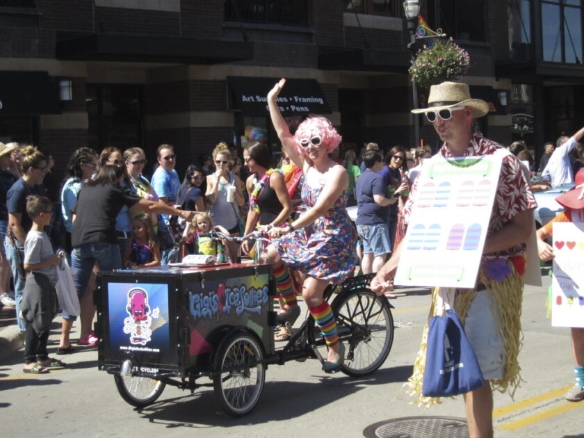 The Fargo-Moorhead Pride Parade drew several thousand people to downtown Fargo to celebrate and support the LGBT community on Sunday, Aug. 21. Many parade participants dyed their hair or wore brightly colored wigs and rainbow-colored clothing. Photo by Helmut Schmidt/The Forum