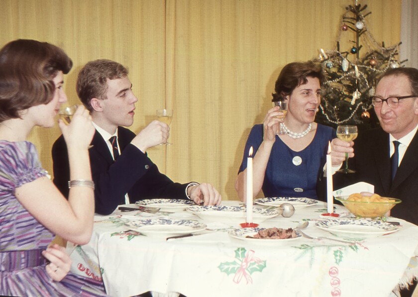 Vintage 1950´s image: family enjoying the Christmas holidays with a dinner.
