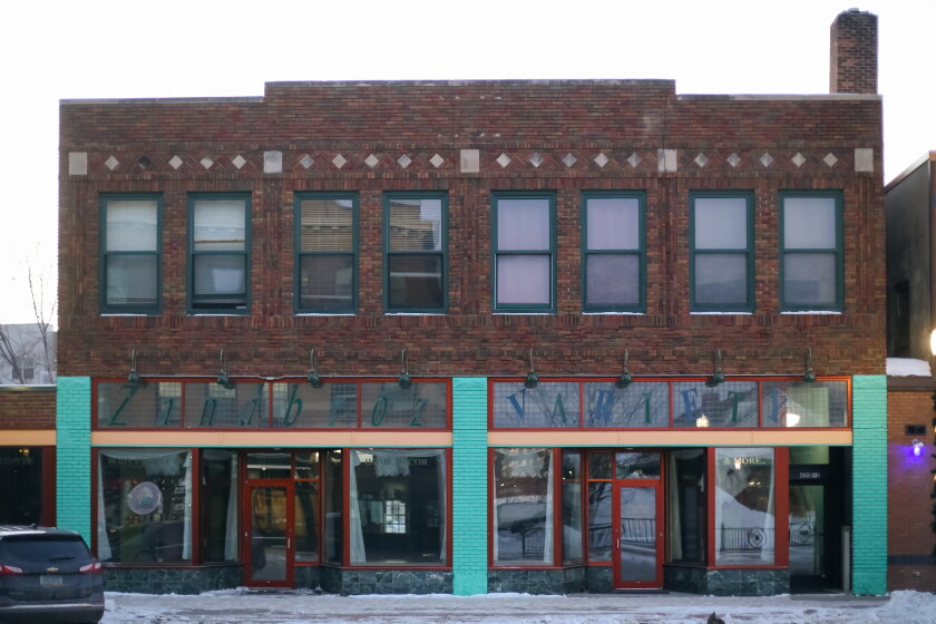 Zandbroz Variety, as seen on Wednesday, Feb. 19, 2025, closed in June of 2024 after 33 years at 420 Broadway. A two story brick building. On the main level some of the brick is painted turquios. The doors have red trim. The windows on the second floor have green trim.