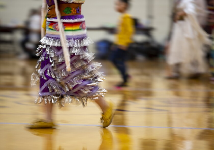 A dancer moves across the gymnasium floor at the UMN Morris Circle of Nations Indigenous Association 37th Annual Powwow on Saturday, April 2, 2022.
