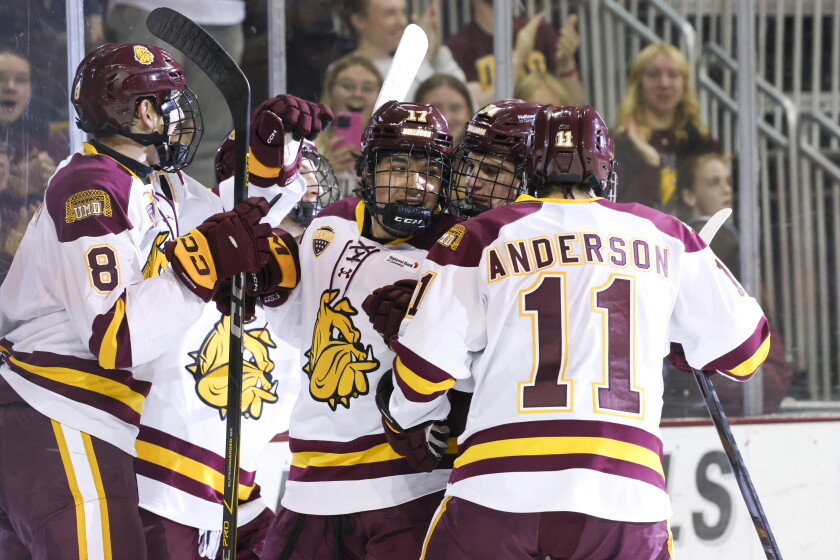college men play ice hockey indoors