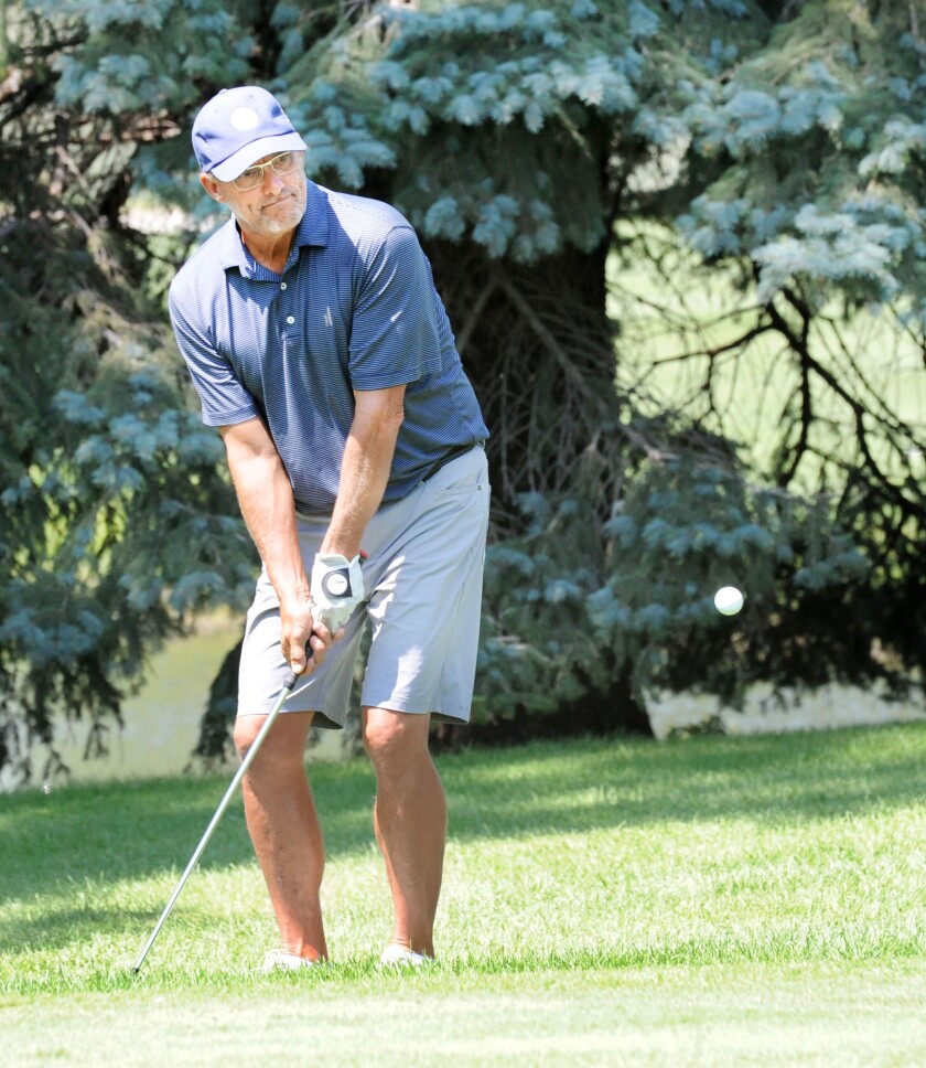 Steve Herzog hits a short chip shot from just behind the No. 6 g