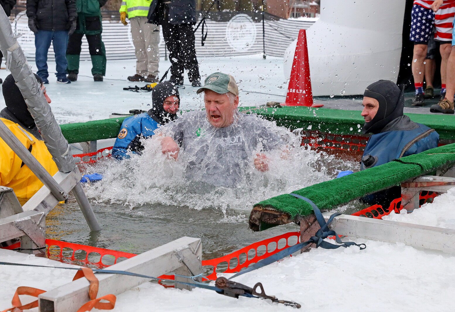 People jump into the water during the Polar Plunge event on Pelican Lake.