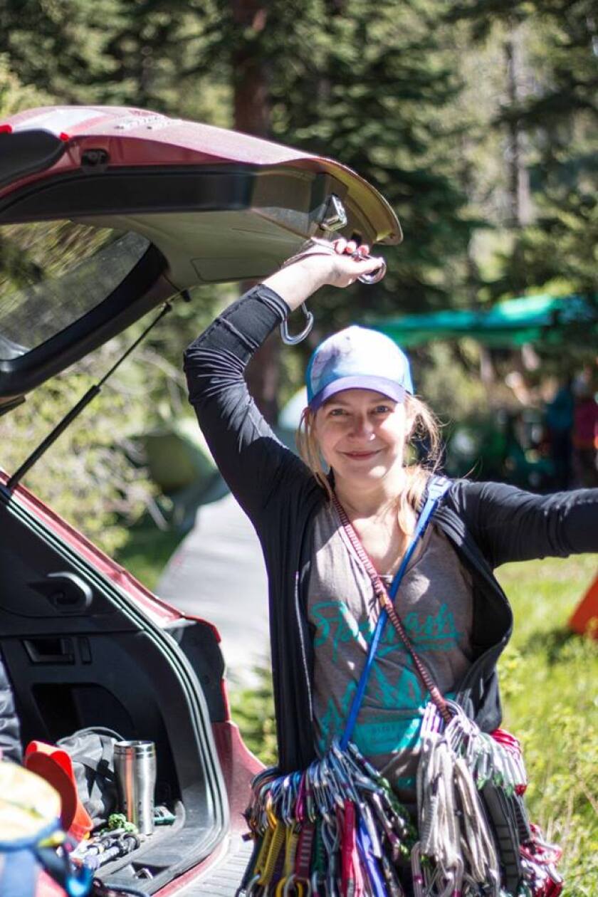 The author poses for a photo with climbing gear stashed around her waist and over her shoulders.