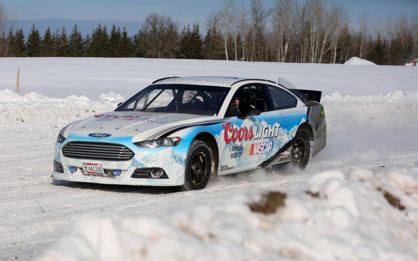 A retired NASCAR Cup Series car driven by Barry Sinex speeds around a turn.