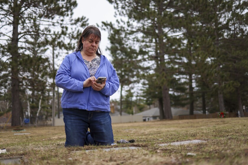 woman documents gravestones