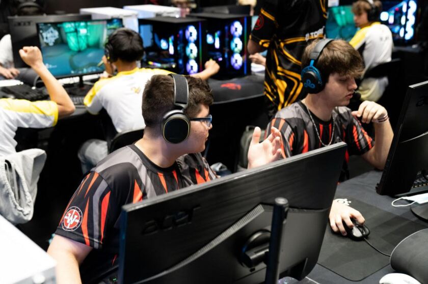Omar Robles talks to a teammate about potential strategies to implement during the state esports competition.