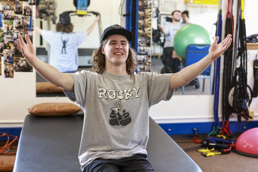 man raises arms into air