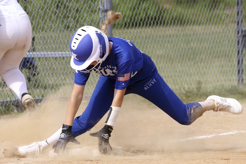 Girl slides into third base.