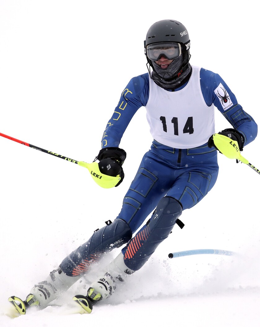 Boy skis around a gate