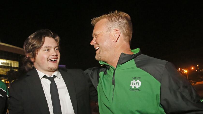 University of North Dakota's Luke Johnson shares a moment with his dad, Steve, at Ferg's after the NCAA Frozen Four championship game at Amalie Arena in Tampa, Fla. David Samson / The Forum