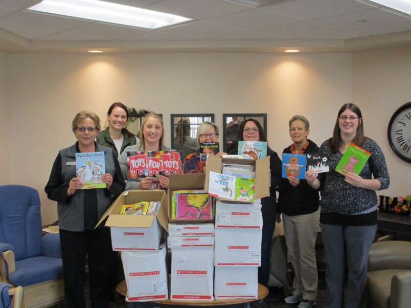 The UPS store and Marine Toys for Tots Foundation encourage childhood literacy and delivered boxes of books to the Dickinson Early Childhood Center pictured. Photo courtesy of UPS Store #4954