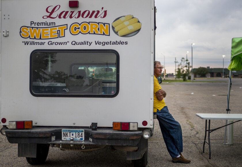 Larry Larson of Larson's Premium Sweet Corn in Willmar watches as patrons browse the selection of homegrown goods at the Uptown Willmar Farmer's Market on Saturday, July 23, 2022.