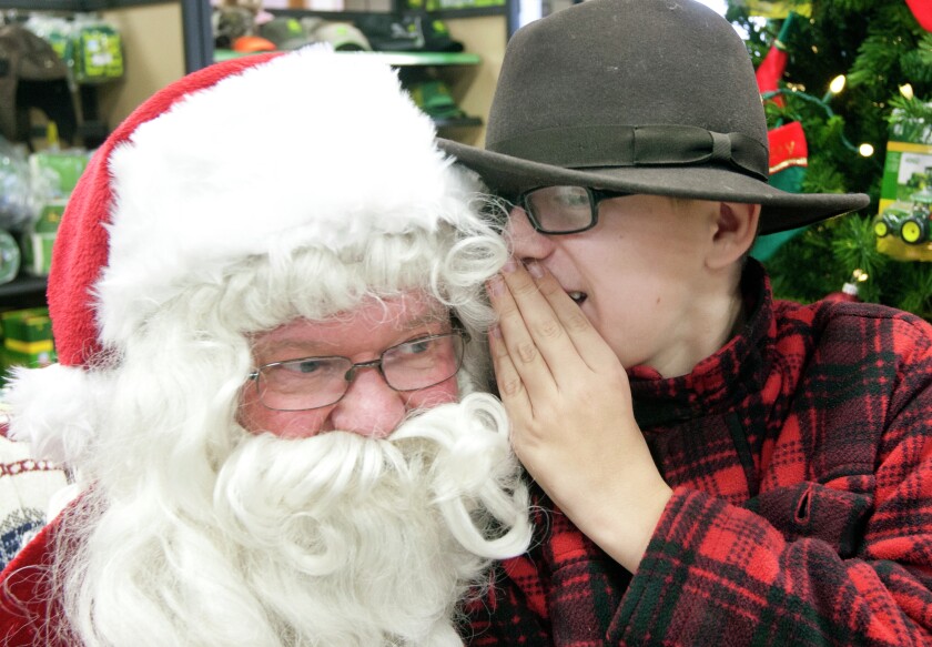 Charlie Kern whispers to Santa what he wants for Christmas