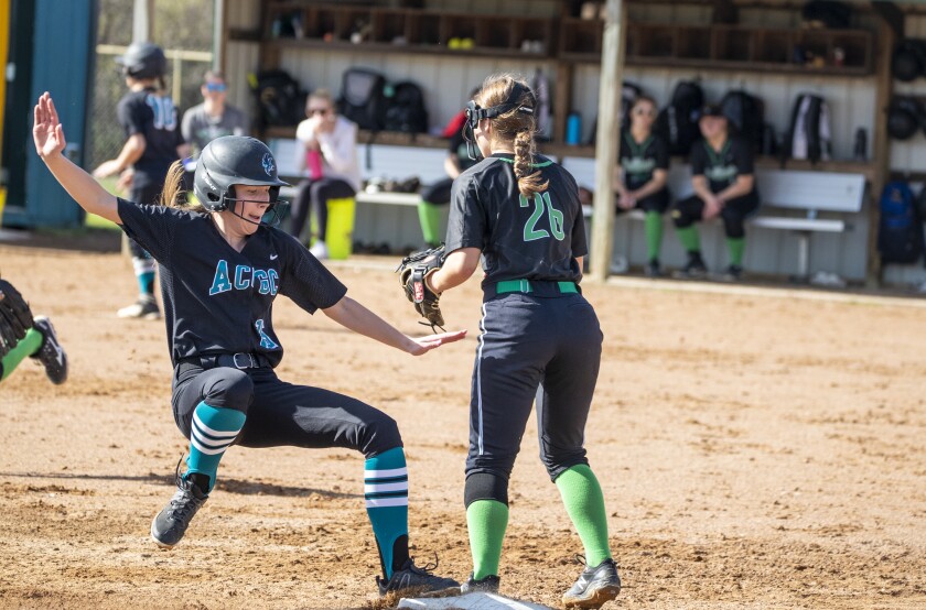 Brooke Schultz, at left, of ACGC slides into third base while playing against the Bulldogs of Paynesville on Monday, May 9, 2022, in Paynesville.