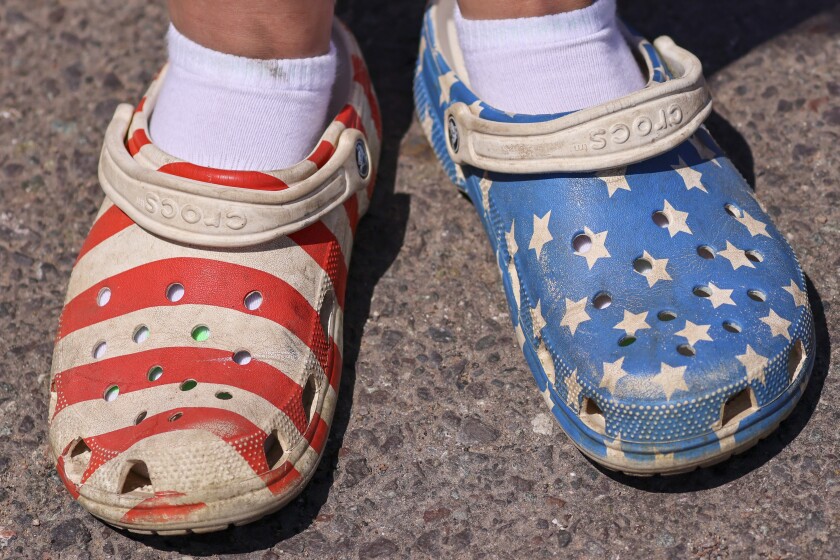 People wearing red white and blue patriotic themed clothing participating in outdoor parade