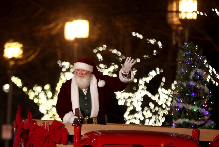 Santa waves to crowd.