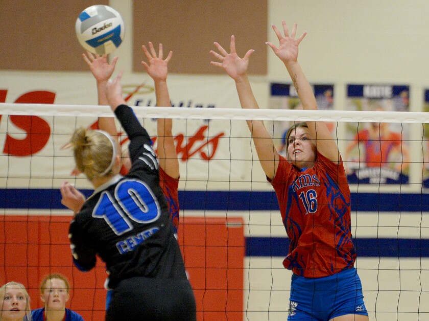 KMS senior Taylor Haats, 16, and a teammate go up for a block against CMCS' Lilly Mellema during a Camden Conference match on Thursday, Sept. 29, 2022 in Kerkhoven.