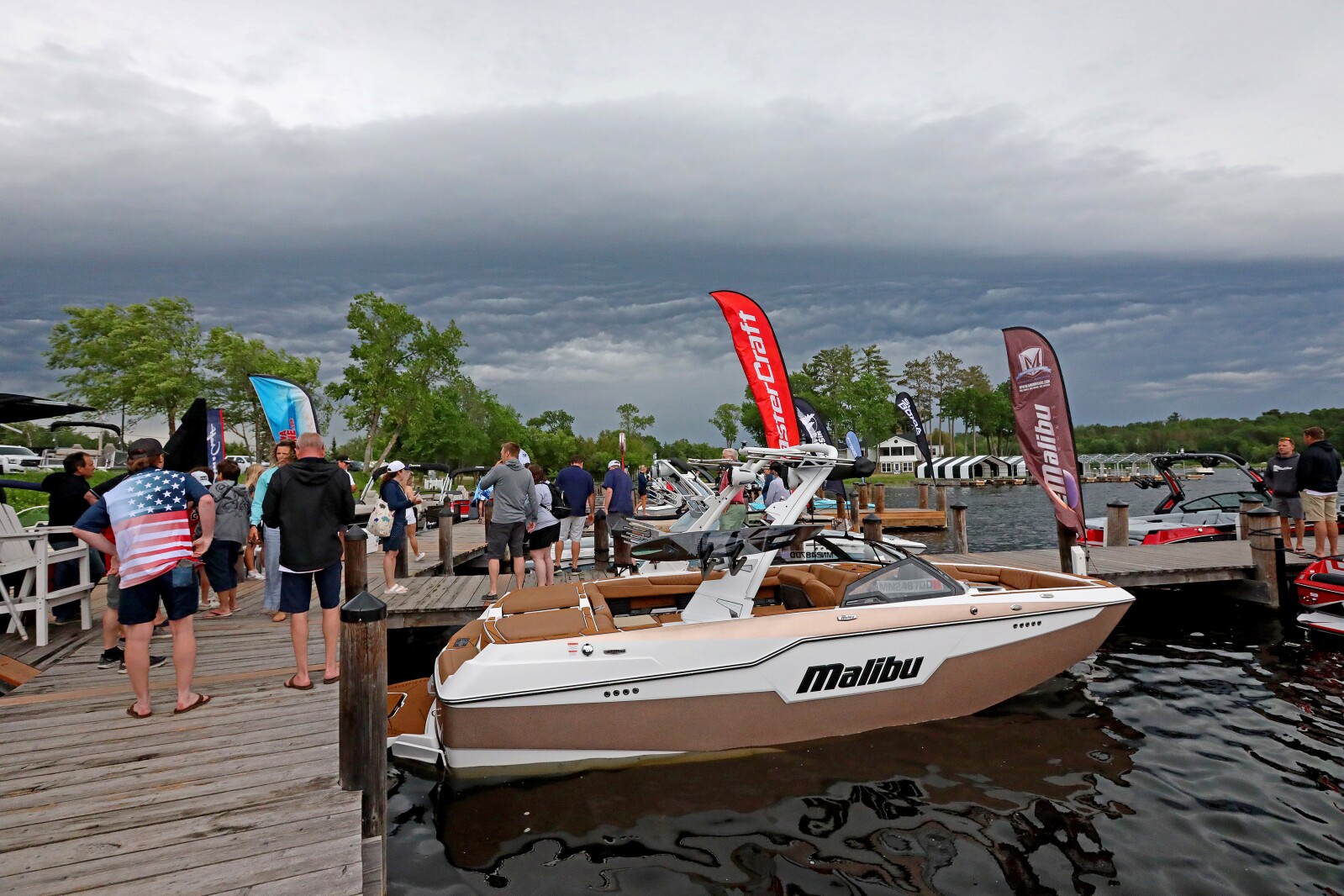 People gather for the ninth annual Bar Harbor In-Water Boat Show on Saturday, June 18, 2022, with boats from Nisswa Marine and Minnesota Inboard Water Sports at the Bar Harbor Supper Club on Gull Lake.