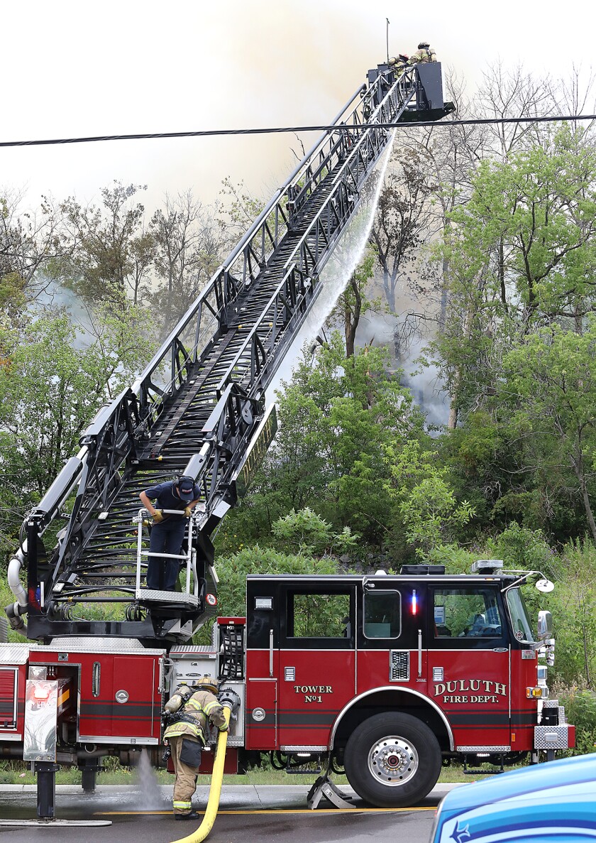 Duluth Fire Department crews work to extinguish a fire at West 1st Street and Piedmont Avenue