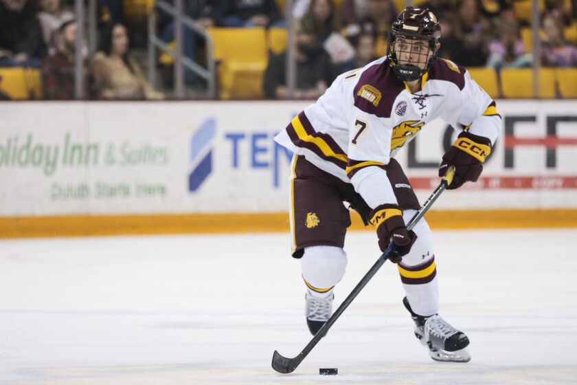 college hockey players play ice hockey