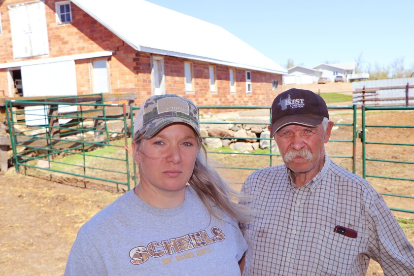 A young ranch woman and her father and partner, stand in the summer where they fought the Blizzard Haley in April 2022.