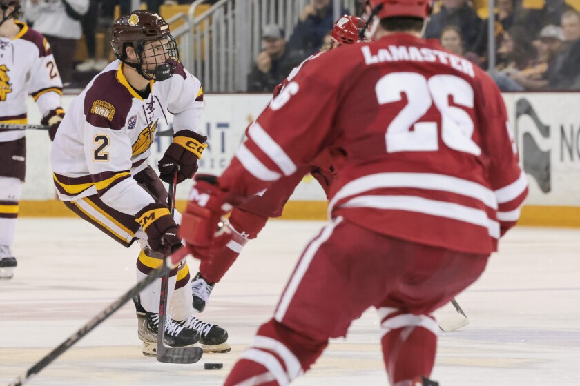 college hockey players play ice hockey