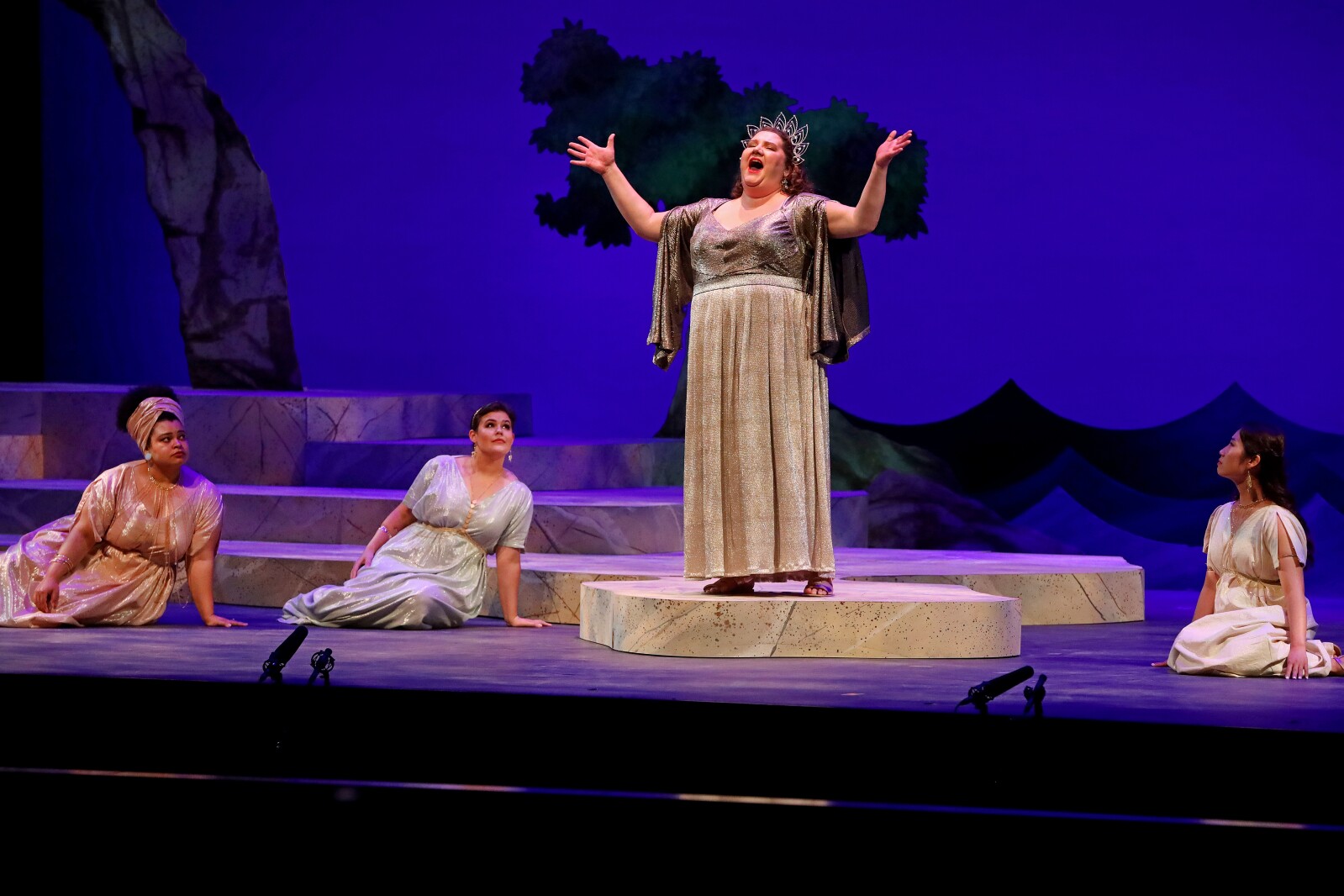 Actors perform on stage.