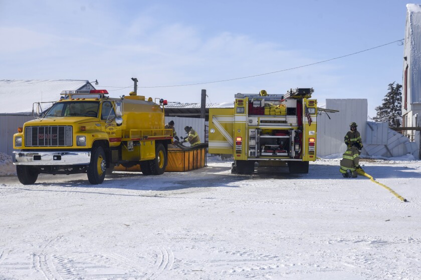 Erica Dischino/TribuneFirefighters with the Blomkest Fire Department work to put out a fire at a cattle farm Friday on Highway 71 south of Willmar. The fire was confined to a skid loader inside a cattle barn. Several head of cattle had to be moved while firefighters put out the blaze.