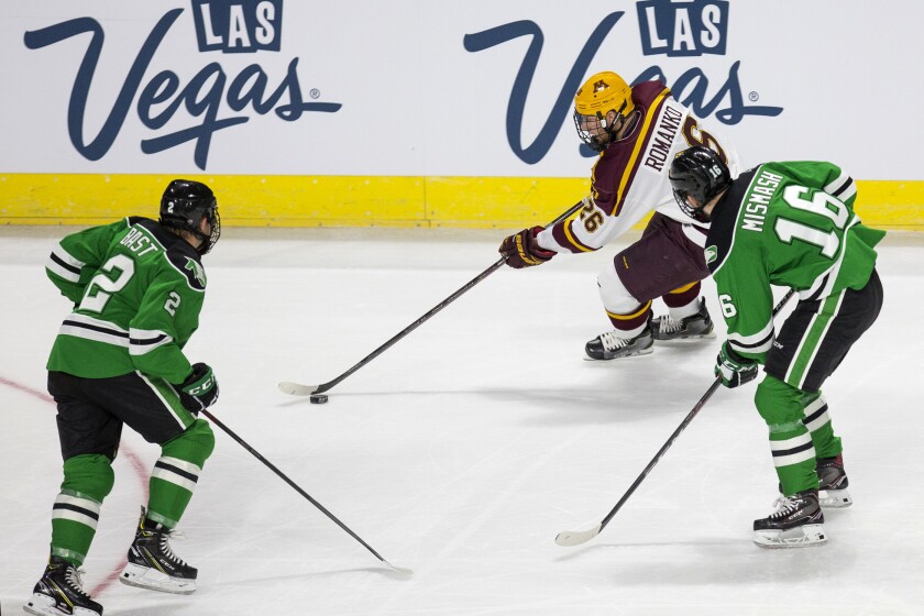 Minnesota Golden Gophers forward Darian Romanko (26) controls the puck as North Dakota Fighting Hawks defenseman Gabe Bast (2) and forward Grant Mismash (16) defend during the first period of the U.S. Hockey Hall of Fame Game at the Orleans Arena in Las Vegas on Saturday, Oct. 27, 2018. Richard Brian Richard Brian Las Vegas Review-Journal @vegasphotograph