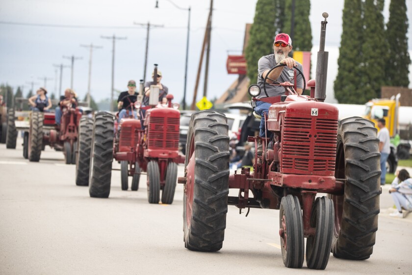 Tractors cruise single file down Lakeview Street during Saturday's Lake Lillian Fun Days parade on August 6, 2022.