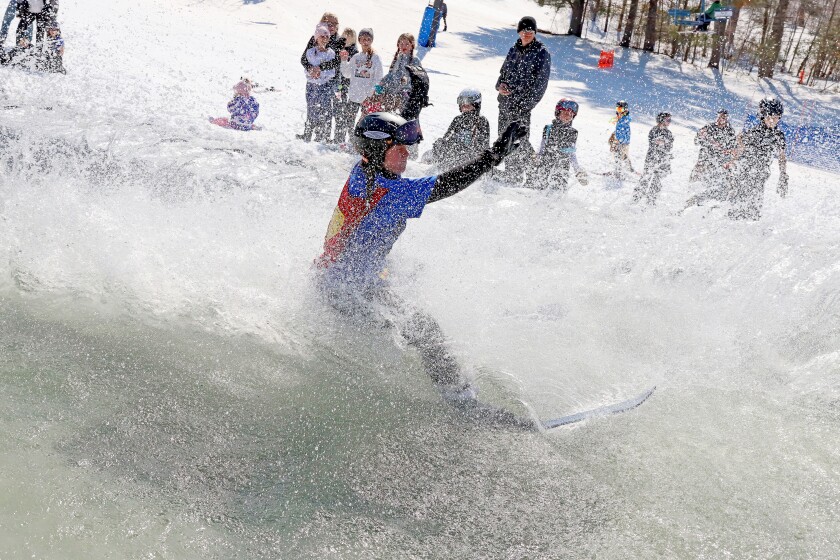 Skiers and snowboarders participate in the water skip at Mount Ski Gull on Saturday, April 8, 2023, for the end of the season.