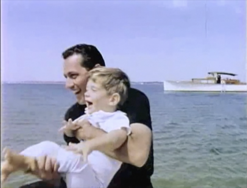 024 1963_Clint laughing holding John on boat__Screen Shot_JFKL.png