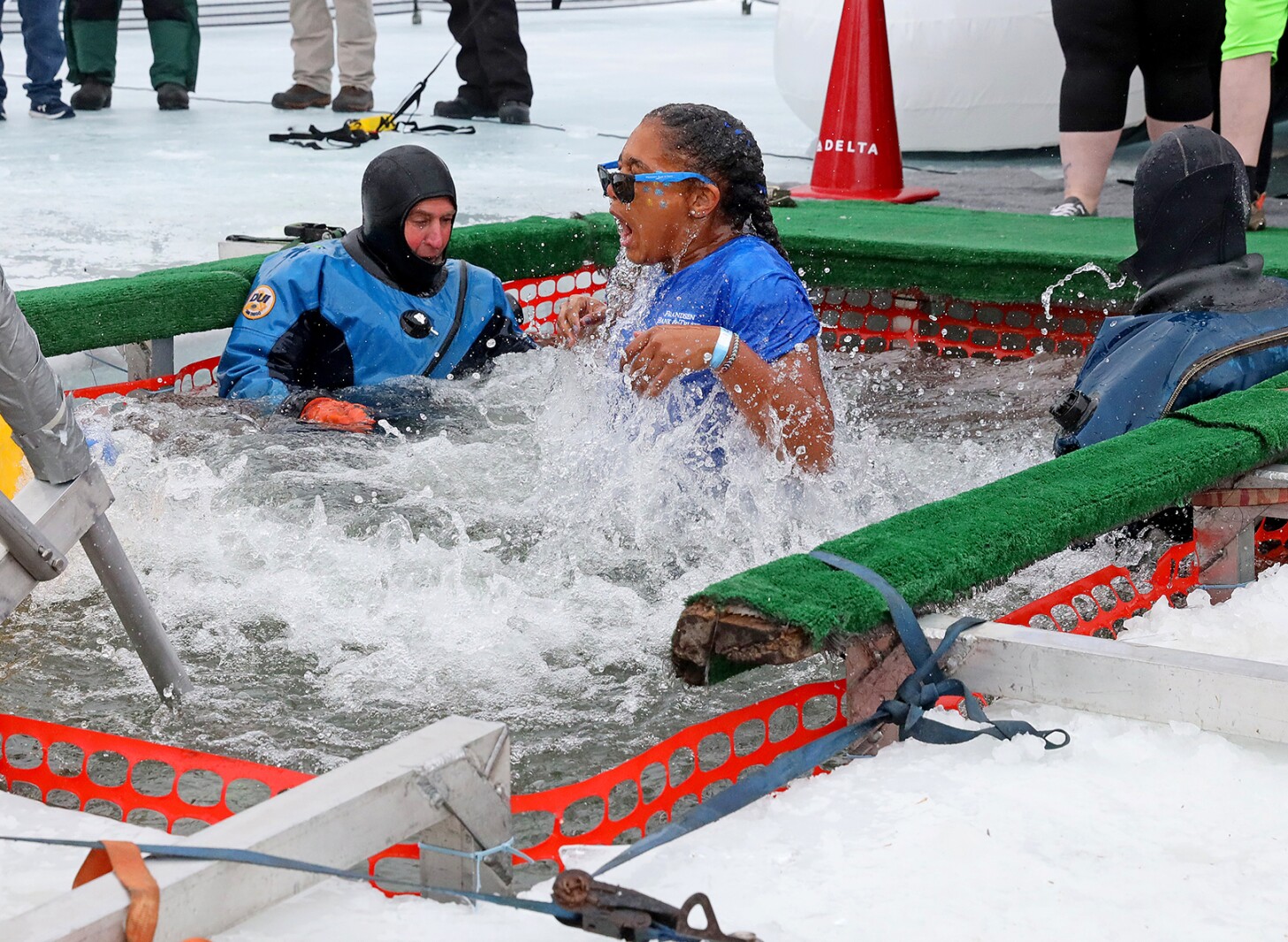 People jump into the water during the Polar Plunge event on Pelican Lake.