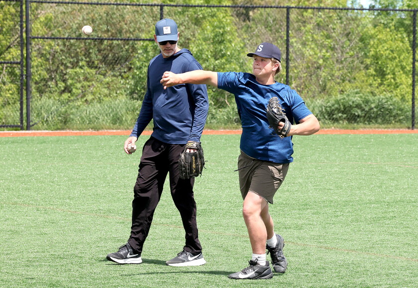 Pitcher shows player drill.