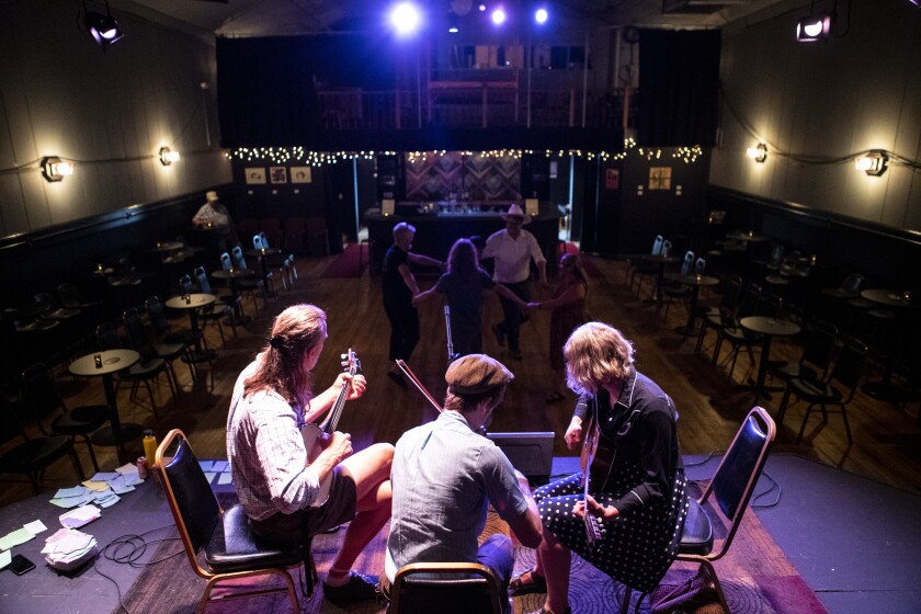The Orla String Band plays music as folks square dance at the Little Theatre Auditorium in New London on Saturday, July 23, 2022.