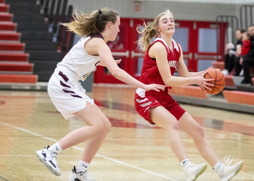 Willmar senior Ellary Lange puts on the breaks after driving the ball up the court as the Cardinals played host to the Fergus Falls Otters Feb. 17, 2022.