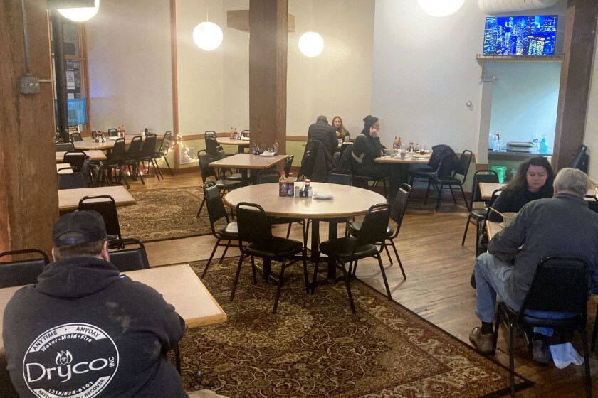 Customers sitting inside of a restaurant.