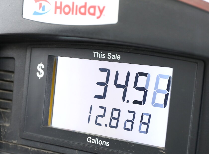 The price goes up on the pump as Garry Hendrickson gets gas at the Holiday station in Scanlon