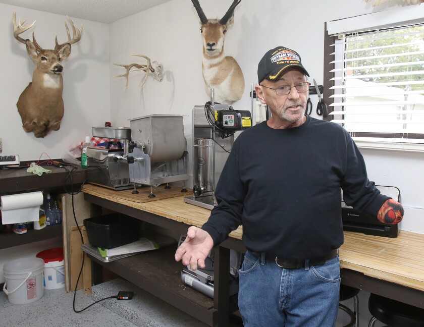 Myron Schlafman talks in his Jamestown garage on Tuesday about the meat grinder accident that took his hand on Aug. 17. He says it was important to get right back to his hobbies. John M. Steiner / The Sun
