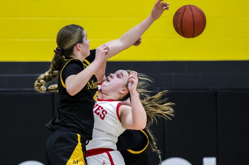 high school girls play basketball