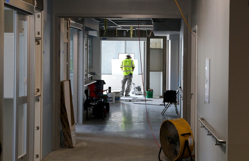 A worker buffs the floors on the eighth floor of the Essentia Vision Northland project