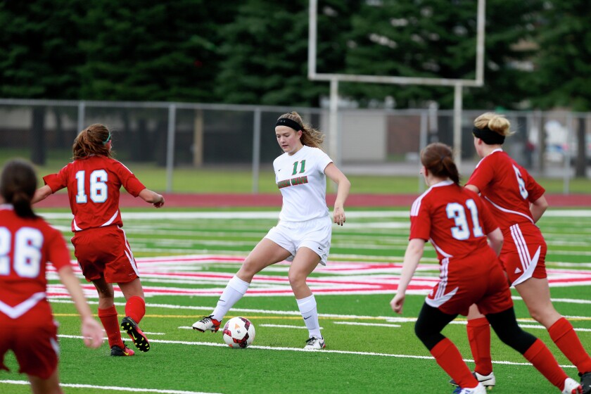 East Grand Forks' Brooke Filipi controls the ball as St. John's Prep players defend during their game Saturday at Senior High in East Grand Forks. photo by Eric Hylden/Grand Forks Herald