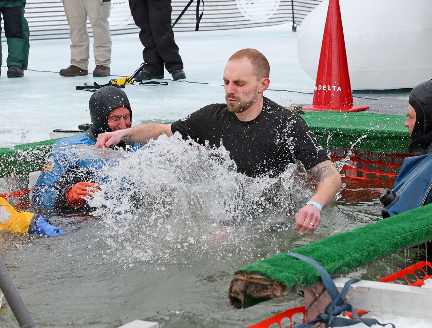 People jump into the water during the Polar Plunge event on Pelican Lake.