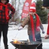 A young girl roasting marshmallows at an outdoor winter event.