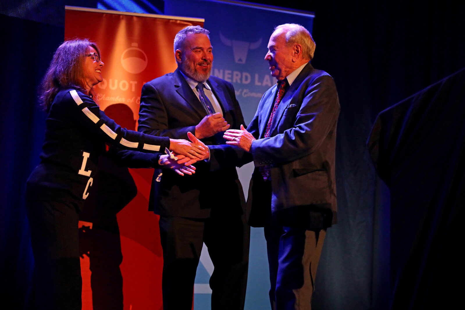 Bob Spizzo, right, comes up on stage to accept the Business Legacy Award during the ninth-annual Brainerd Lakes Chamber of Commerce Celebration of Excellence award dinner Nov. 17, 2022, at Cragun's Resort on Gull Lake near Brainerd.