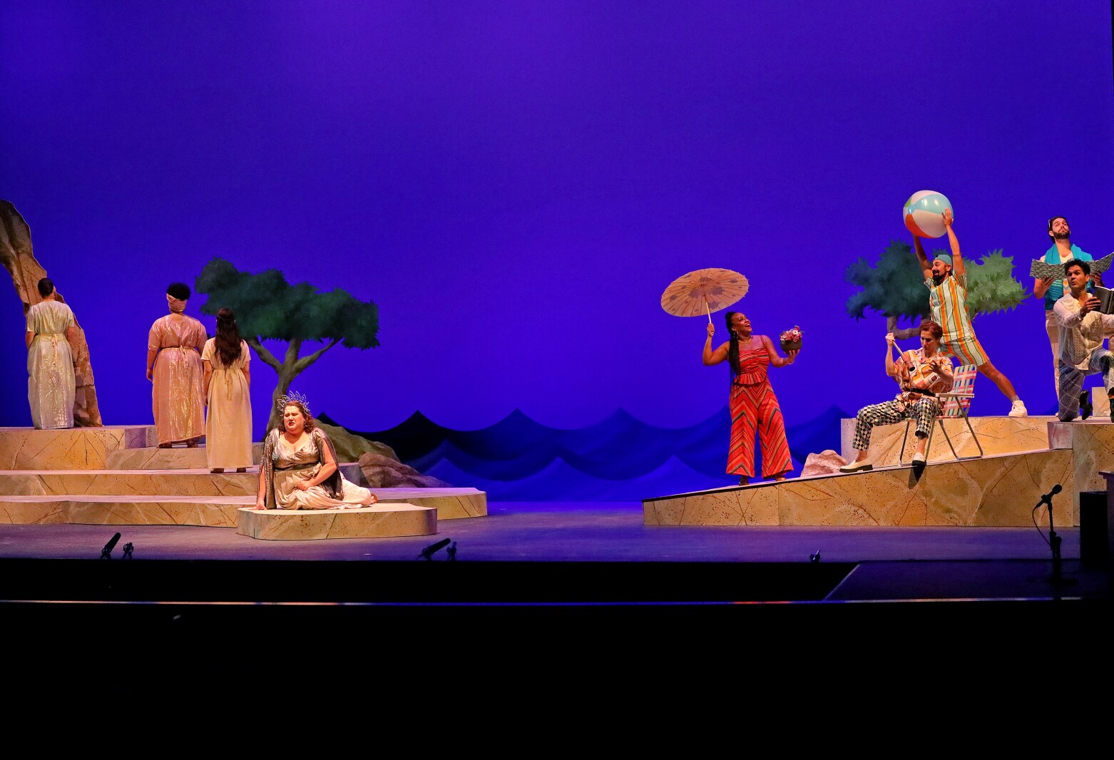 Actors perform on stage.