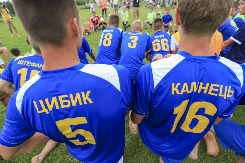 Soccer players in blue and yellow jerseys